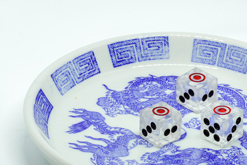 three point dice in bowl on white background