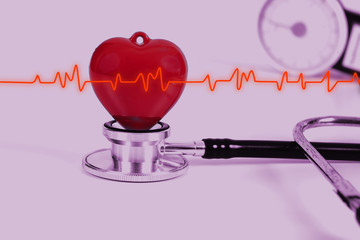 Stethoscope with red heart on white table .Medical accessories with copy space.
