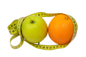 Orange, apple and measuring tape on a white background, isolate. Diet, proper nutrition