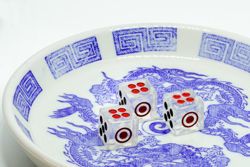 twelve point dice in bowl on white background