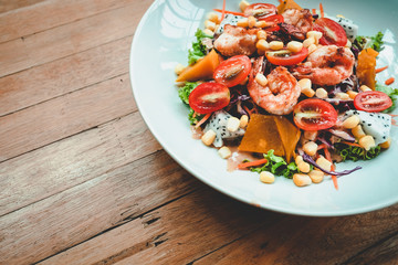 Salad,grilled shrimp,tomato,Dragon fruit mixed on wood table background