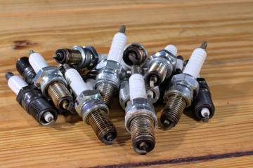Bunch of spark plugs on wood table