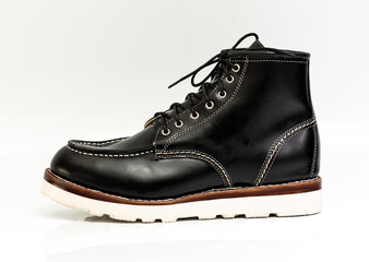 Men’s black boot with oil pull up leather isolated on a white background.