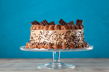 Decorated chocolate cake on dark background
