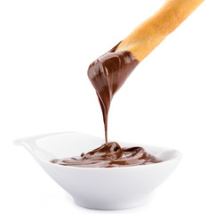 Grissino con crema di nocciola su fondo bianco