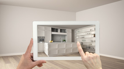 Augmented reality concept. Hand holding tablet with AR application used to simulate furniture and...