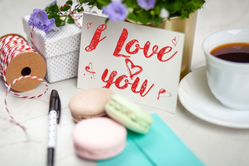 I Love You postcard on white marble table