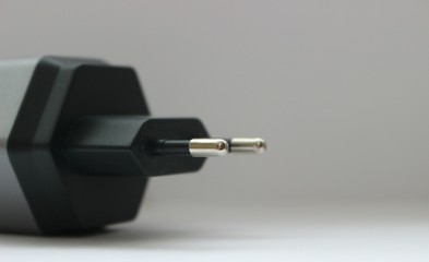 white background electronics appliances technology socket voltage current light black gray power two connection adapter plastic metal shadow gray stationery office modern