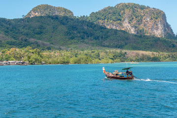 A Longtail boat approaching the island of Koh Mook,Thailand. February 2019.