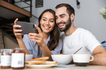 Happy multiethnic couple having breakfast