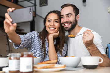 Happy multiethnic couple having breakfast