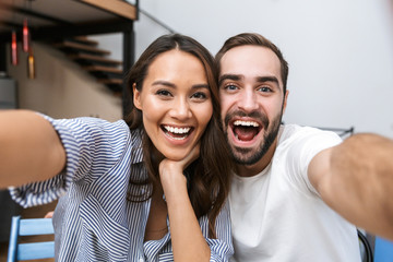Cheerful multiethnic couple taking a selfie