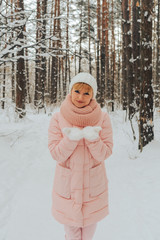 Woman walks in the winter forest. Woman portrait on the background of the winter forest.