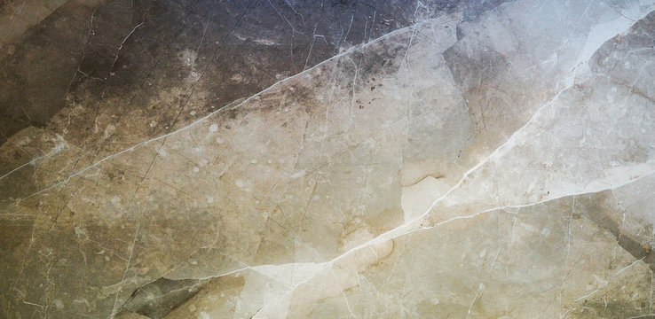 The texture of natural stone (granite, marble) on the floor of a large stoneware tile