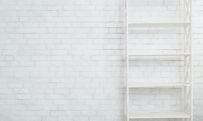 White wooden rack on brick wall