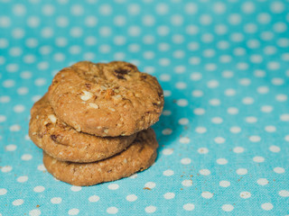 Oatmeal and raisin cookies on pastel blue polka dot background.