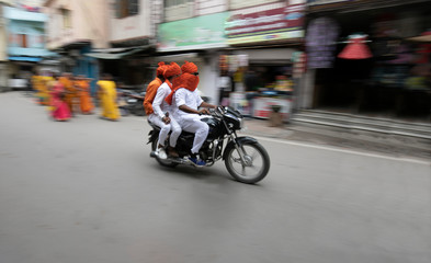 3 person traveling in bike in ethnic clothes