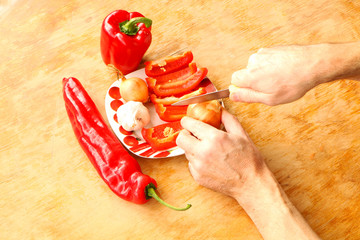 Healthly food - Cook hands cutting up a salad .