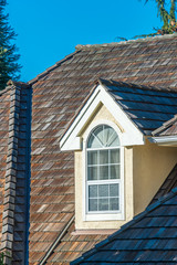 The top of the house or apartment building with nice window.