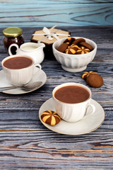 Obraz na płótnie Canvas Cups with cocoa on a wooden table