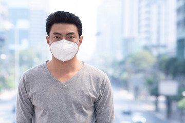 Asian man wearing protective masks in city, Asia traveler wear mask protection, air pollution in city