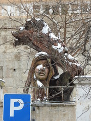 Figure of a girl carved from a tree trunk