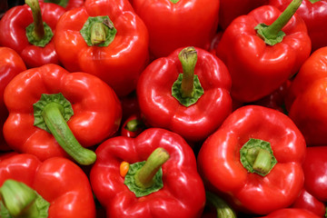 Obraz na płótnie Canvas Top View of Heap of Fresh Ripe Red Bell Peppers with Green Stem