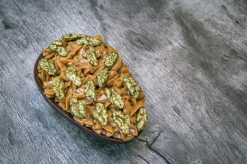 Chocolate egg with filling for Easter on wooden background.