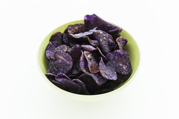 Heap of purple potato chips on white background