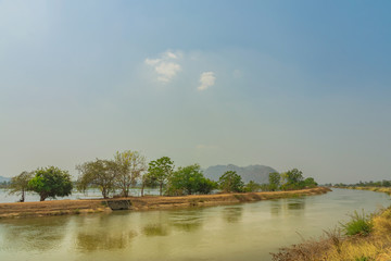 View of Water management in the rice fields from the irrigation canal before planting in Kanchanaburi, Thailand.