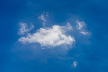 Fluffy white clouds on a blue sky, background