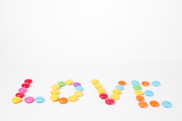 Inscription LOVE made from colorful sweet candies.