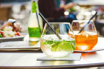 Aperol spritz and HUGO cocktail in misted glass, selective focus .