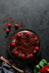 Chocolate cake with fruits on dark background. Top view with copy space.