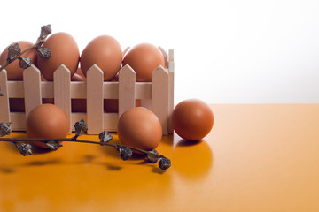vintage easter egg food with white basket wood on yellow background with dried flower