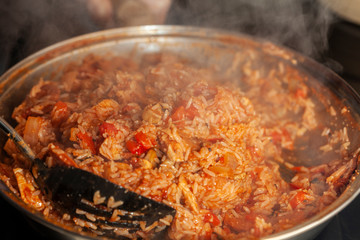 Chicken and Chorizo Jambalaya being stirred in a pan