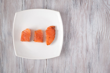 light-salted salmon on a light wooden background