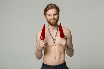 Smiling young man with beard and trendy hair with naked torso