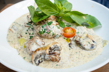 Tasty risotto with Shrimp, fresh herbs vegetables on a white plate