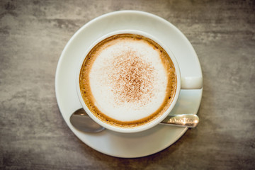 Hot coffee and hot tea place on the marble table in early morning with copyspace, white cup and silver spoon.