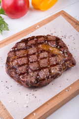 Grilled beef steak served on board