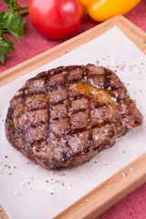 Grilled beef steak served on board