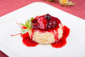 Cake with berries and red syrup