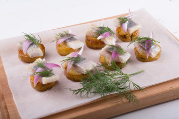 Salted raw herring with potato and dill