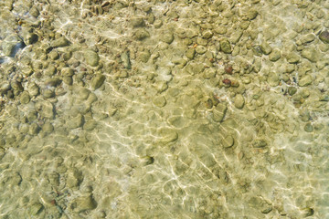Top view of sea water surface with rock
