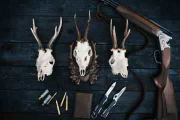 Professional hunters equipment for hunting. Rifle, knives, trophy sculs, ammunition, and others on...