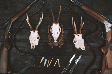 Professional hunters equipment for hunting. Rifle, knives, trophy sculs, ammunition, and others on...