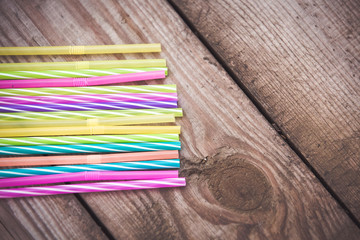 Fototapeta na wymiar Plastic straws on wooden background plastic free concept