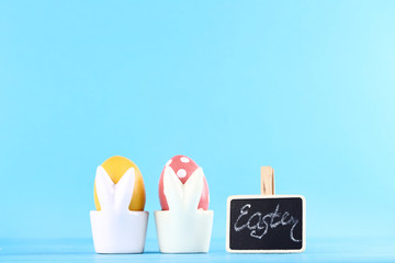 Colorful eggs with text Easter on blue background
