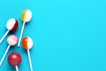Sweet lollipops on blue background